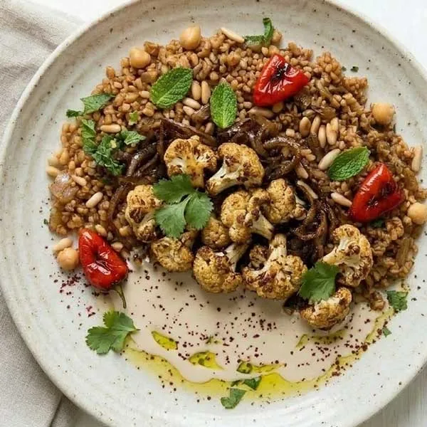 Roasted cauliflower musakhan-style with sumac onion & tahini drizzle